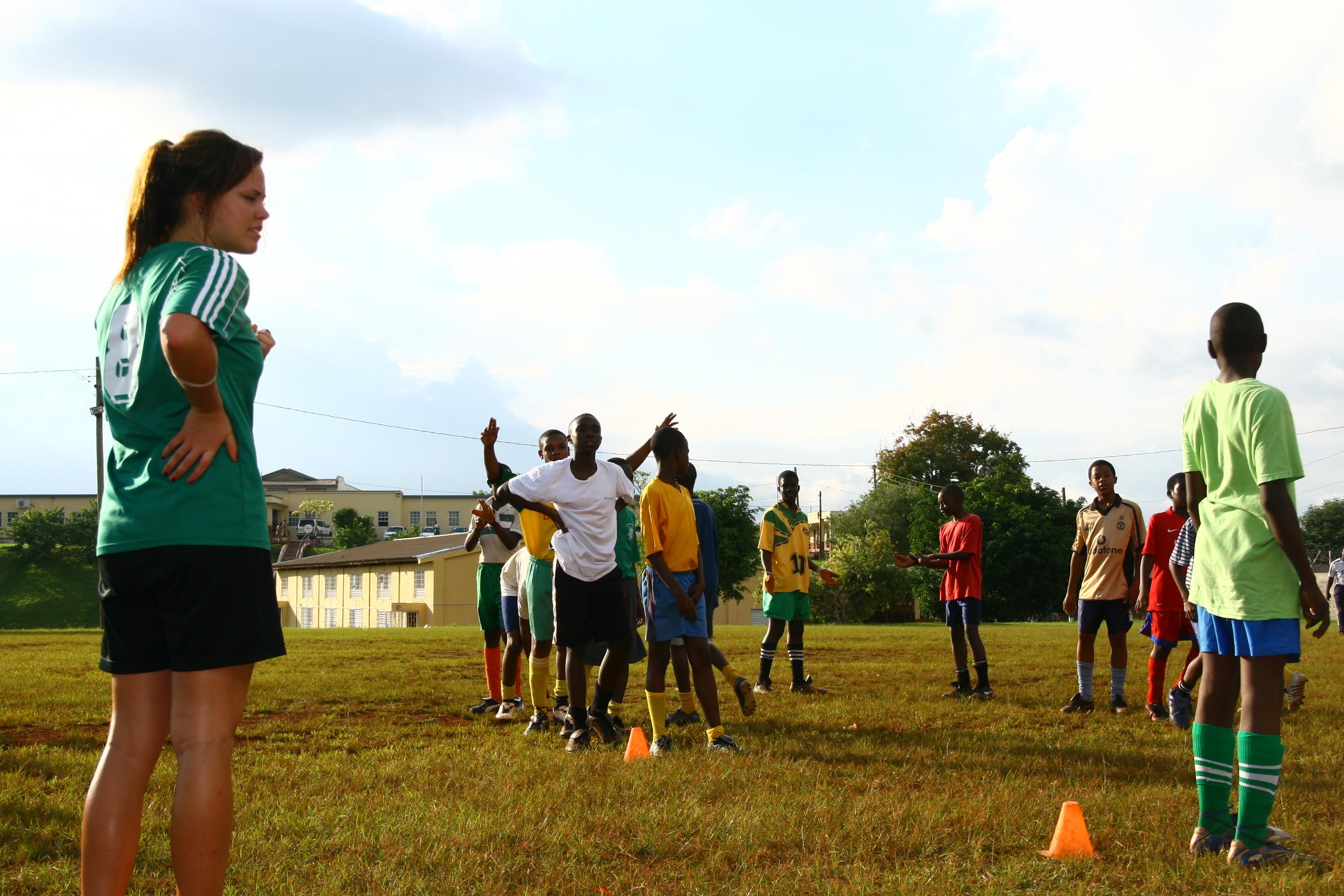 A football player volunteers as a sports coach in schools in Jamaica Players practise football drills through Projects Abroad's volunteer sports coaching in schools in Jamaica